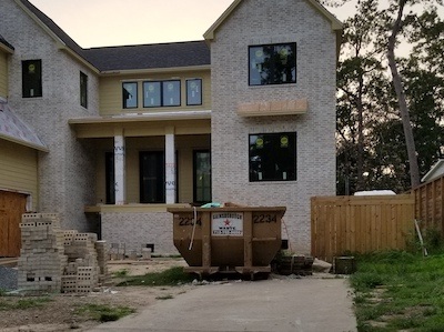 A driveway dumpster in use during a new, residential, construction project.
