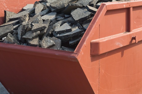 Waste asphalt pavement and concrete materials in a container for asphalt recycling