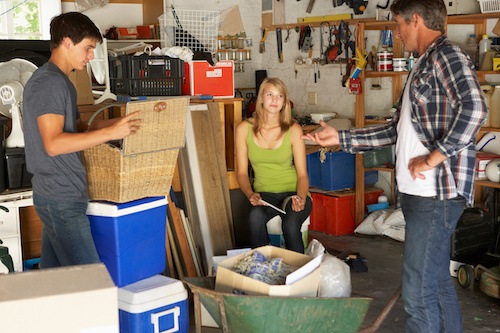A family working together to clean out a hoarder’s garage