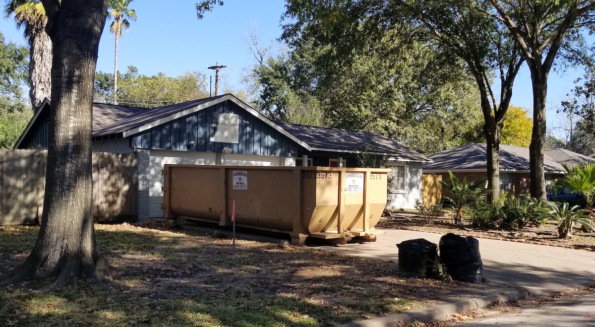 A roll-off dumpster in use for a home improvement project in Houston