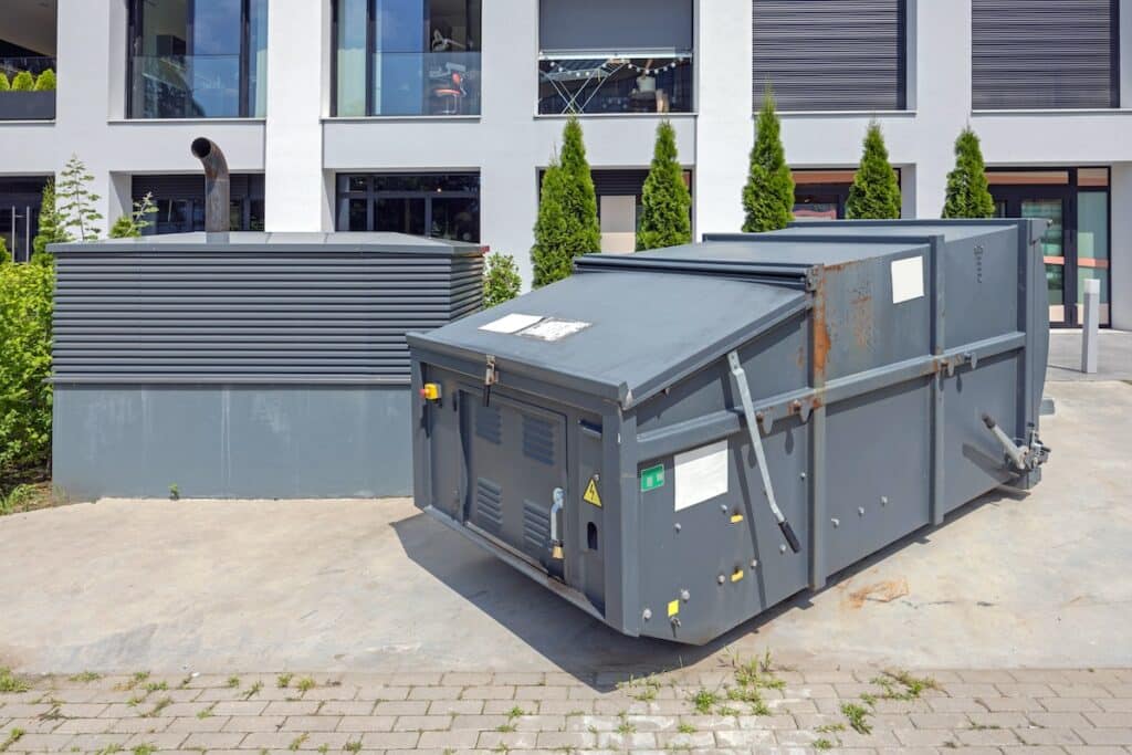 Waste compactor placed outside of a place of business